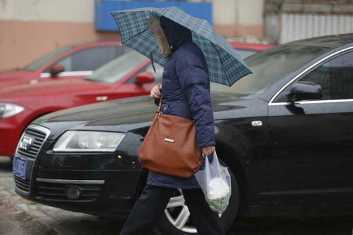 下午五点左右，劲松桥东下起雨，行人纷纷打伞或用报纸遮挡避雨。新京报记者高玮摄src="http://y0.ifengimg.com/cmpp/2014/02/26/18/c6176841-7ca7-44b5-932a-0d97570c3dc3.jpg"