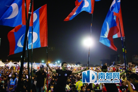 3月21日晚，马来西亚加影体育场，加影补选前的反对派大型集会上，反对派的支持者在挥舞旗帜。