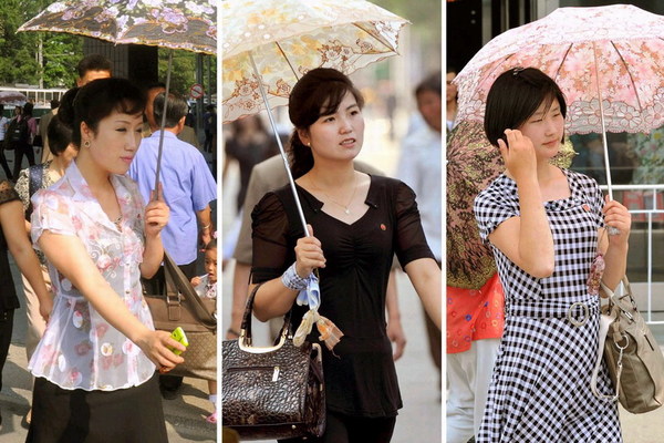 朝鲜女子手持阳伞走在平壤街头,照片摄于6月(网页截图)