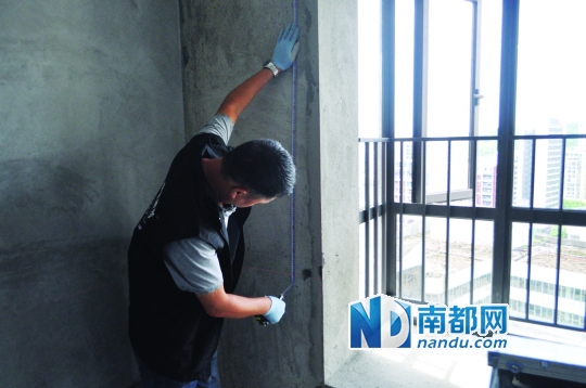 验房师在测量墙壁的平整度。