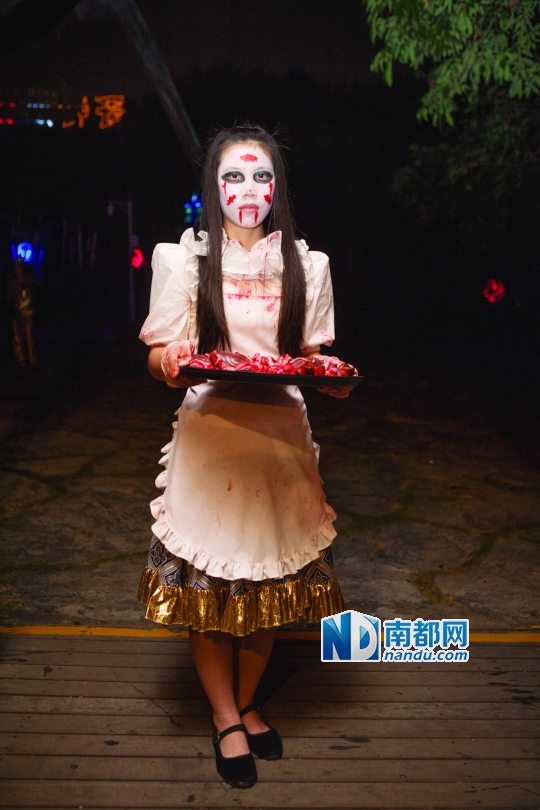 黄杏坚,18岁,广西人,白天她是欢乐谷欢乐商场收银员,入职6个月,今年第一次参加万圣节扮演血腥女仆,旅客争相和她合影让她很开心。