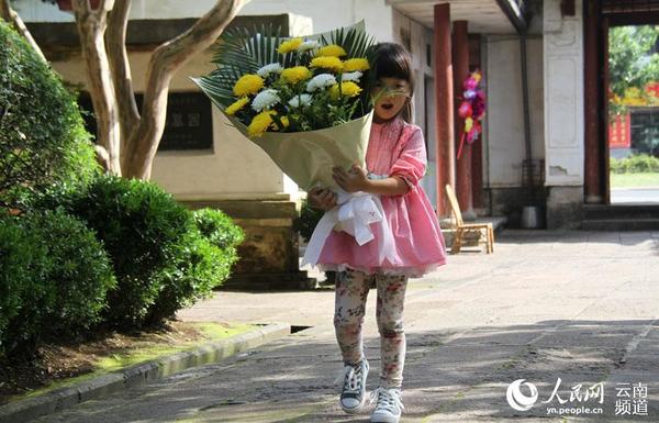 9月4日上午，一位小朋友在父母的带领下前来国殇墓园敬献鲜花，缅怀先烈。人民网 虎遵会 摄