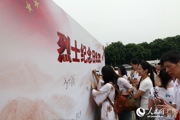 与会嘉宾在看板上签名留念。