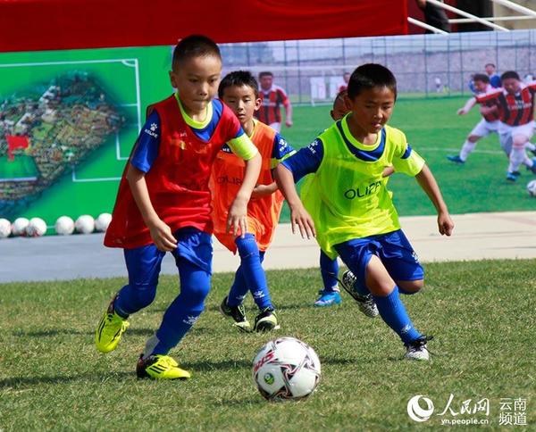 10月30日下午，云南泸西县在泸源中学举行全国青少年校园足球试点县建设启动仪式。图为少儿球员在启动仪式赛场上奋力拼抢。（人民网 李发兴 摄）
