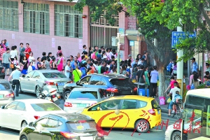 家长在东风西路小学门前接送小孩。(资料图片)