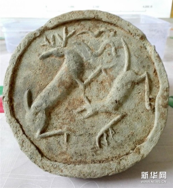 这是考古发掘出的双鹿纹瓦当（手机照片，2015年12月29日摄）。