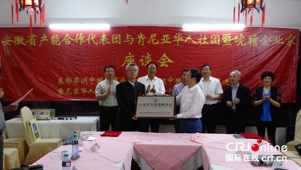 安徽省外事侨务（港澳）办公室主任王信（前右）向东部非洲中国总商会暨中国和平统一促进会主席韩军授牌。 （摄影 王新俊）