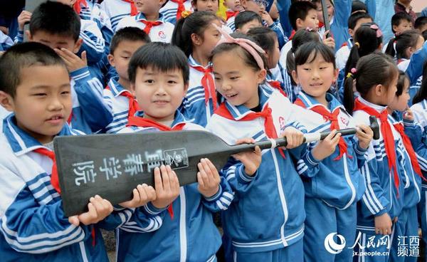 宜春学院龙舟男队的教练和队员与鄱阳的小学生们零距离互动。