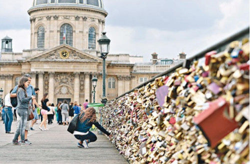 　　艺术桥的栏杆挂满了爱情锁。（图片来自《新明日报》）
