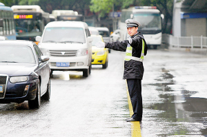 5月21日中午,沙坪坝三角碑转盘,交巡警冒雨疏导交通.