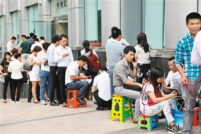 去年年底,市民在深圳市房地产权登记中心排队等候取号.(资料照片)