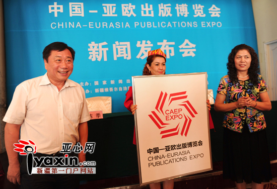 (版权)局局长古力先·吐拉洪(右)为中国——亚欧出版博览会的会徽揭幕